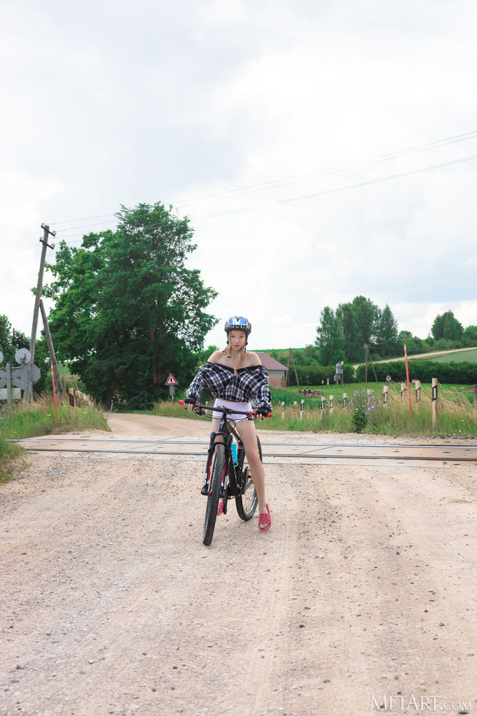 Mirka Cycles Through Belarussian Countryside Exposing Perky Nipples And Gloved Fingers Teasing Her Shaved Pussy - Photo 03