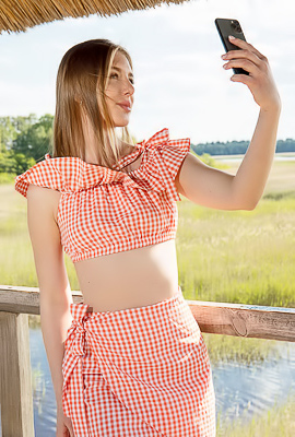 >Karianne Bending Over The Railing With A Smile