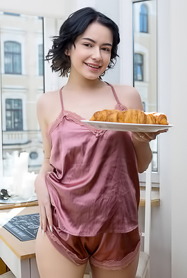 Baiba Her Curly Black Hair Framing Her Face Like Playful Ink Strokes On Porcelain